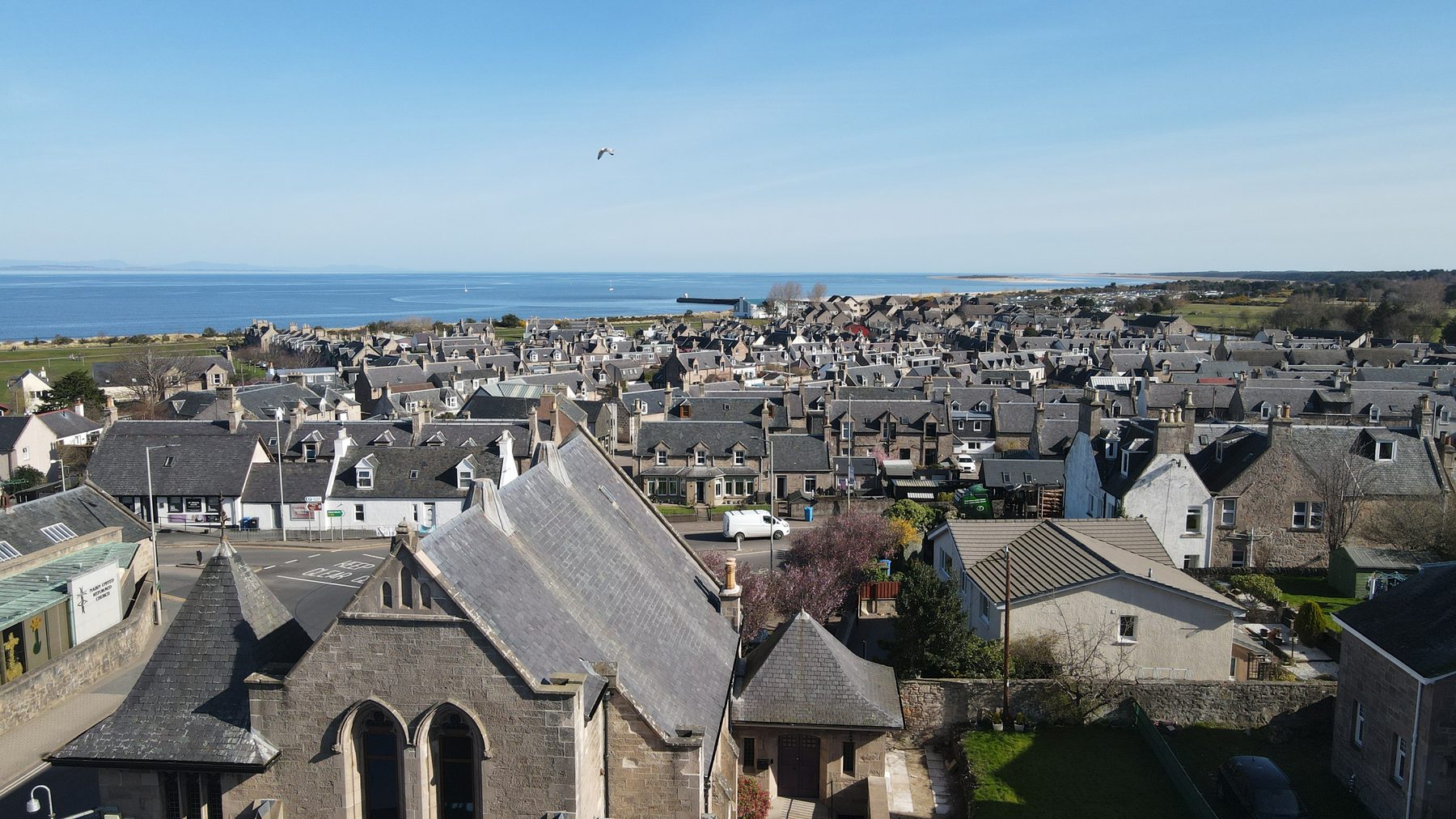 Aerial view over Nairn rooftops toward the Moray Firth